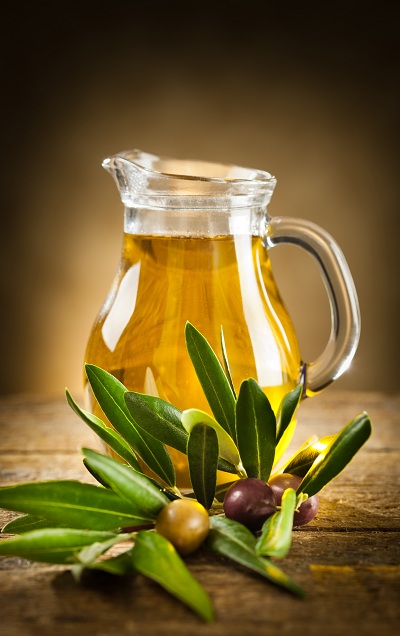 A pitcher of olive oil on the table