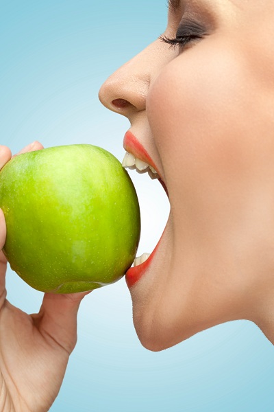 Biting a green apple