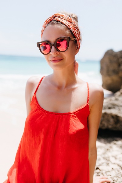 Female model outdoors posing in her red dress