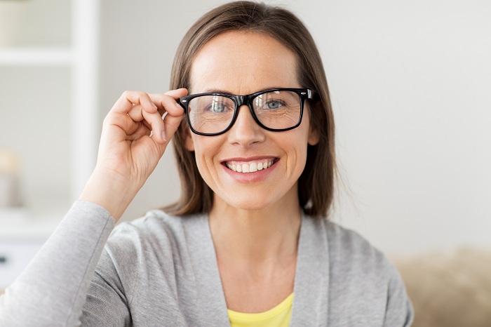 Happy middle aged woman in glasses at home