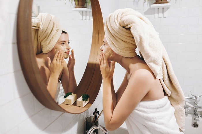 Happy woman applying face mask overnight