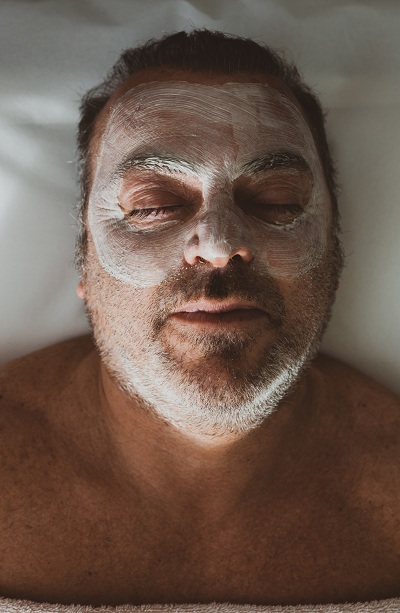 Middle aged man having a facial spa treatment