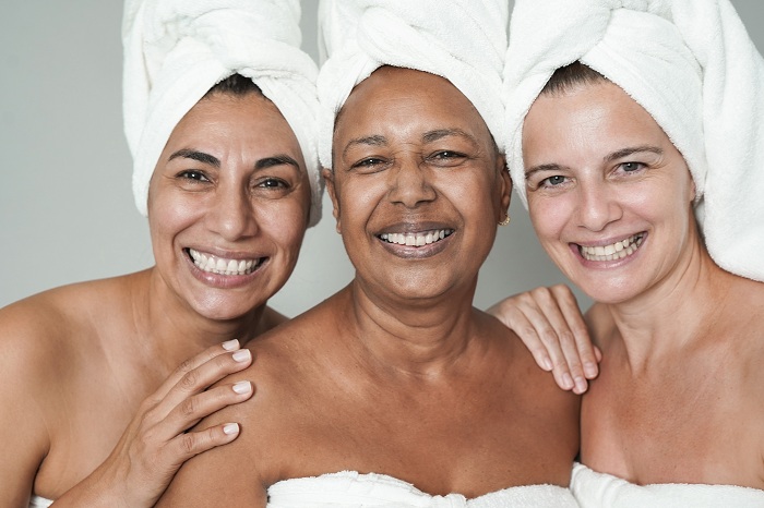 Multiracial women doing the same skincare routine
