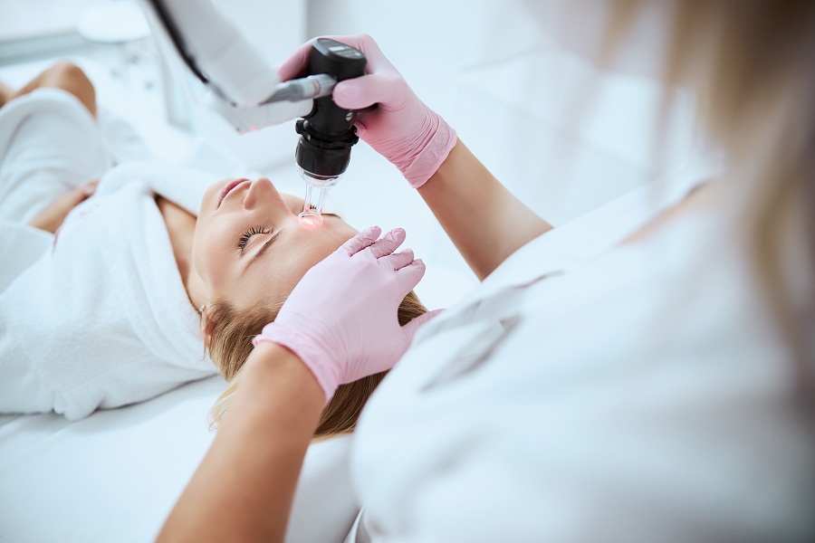Woman having facial resurfacing procedure