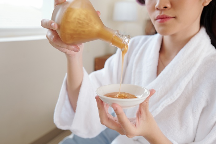 Woman pouring homemade moisturizer