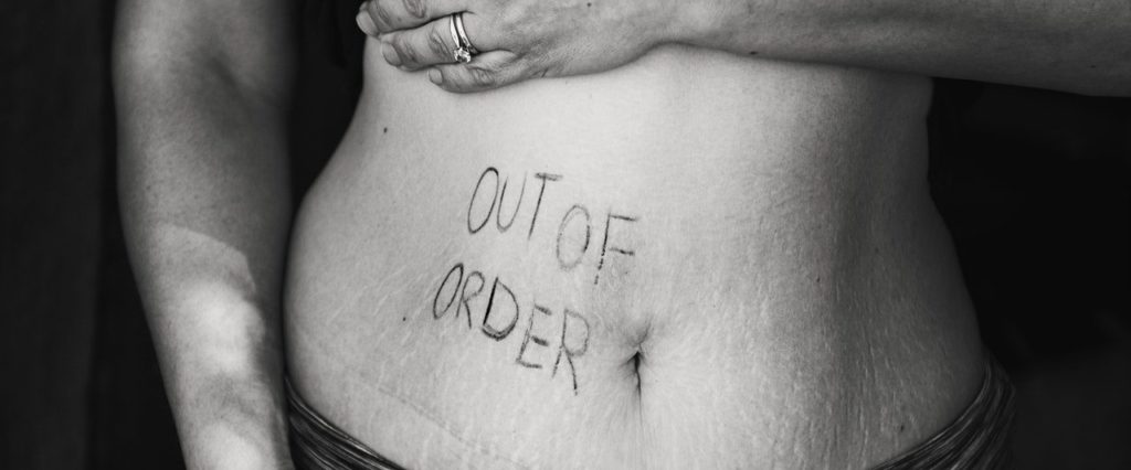 Woman showing her tummy with out of order phrase