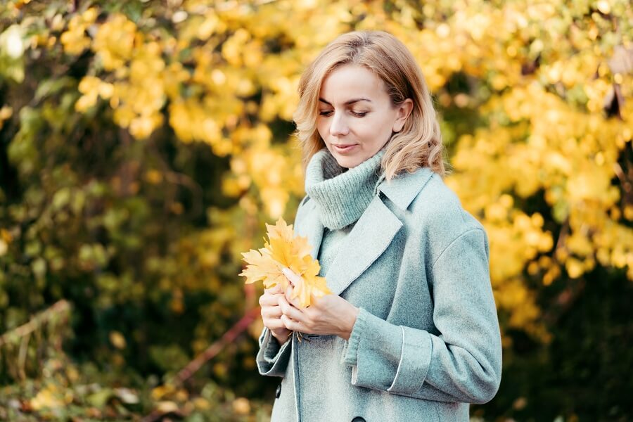 pretty middle aged woman in autumn season outdoors