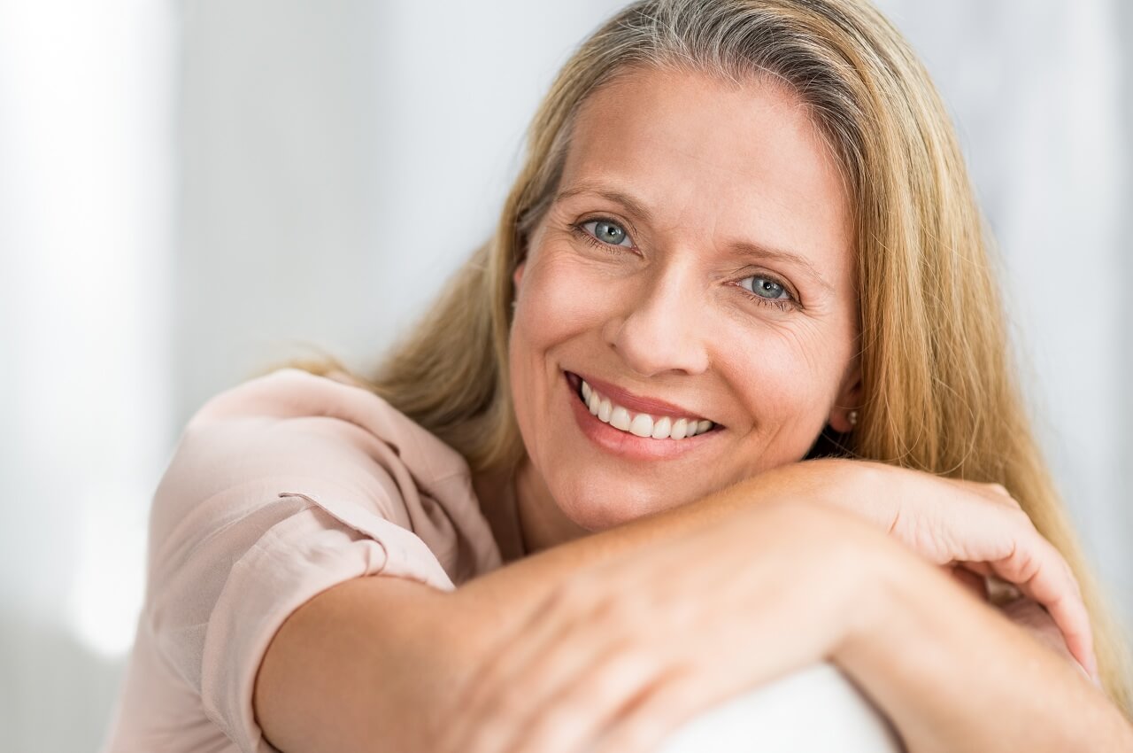 smiling mature woman on a couch