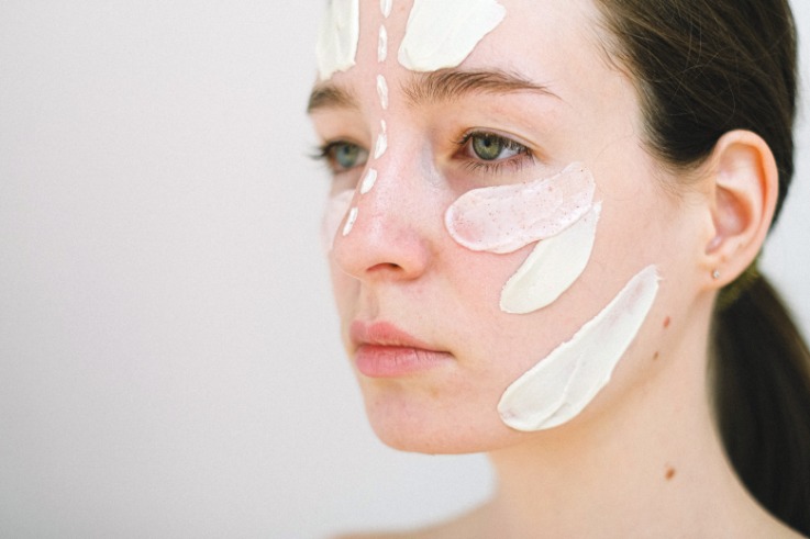woman with face moisturizer