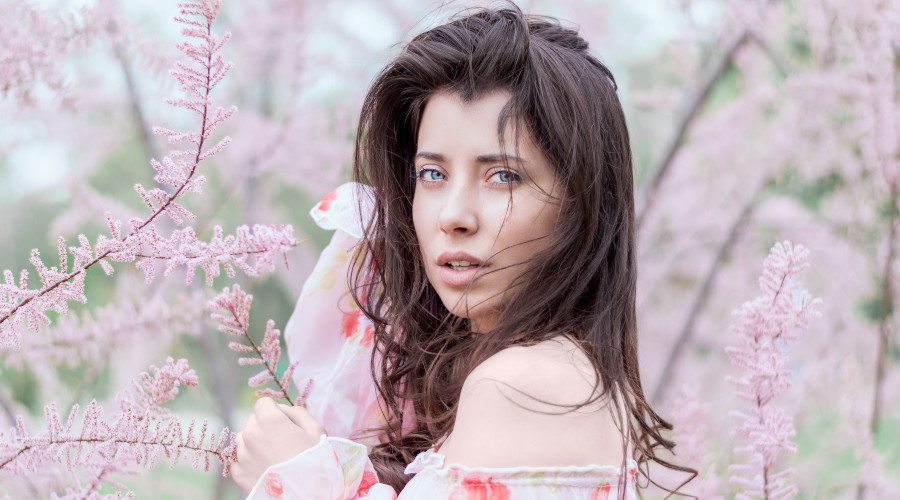 Woman surrounded by pink flowers